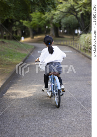 A girl riding a bicycle 119605256