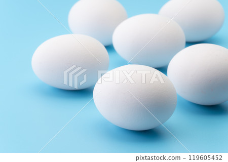Close-up of eggs on light blue background 119605452
