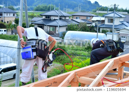A two-story wooden house built using the wooden frame construction method by carpenters and other craftsmen. 119605694