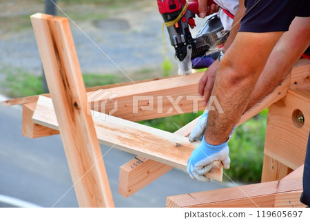 A two-story wooden house built using the wooden frame construction method by carpenters and other craftsmen. A two-story wooden house built using the wooden frame construction method by carpenters and other craftsmen. 119605697