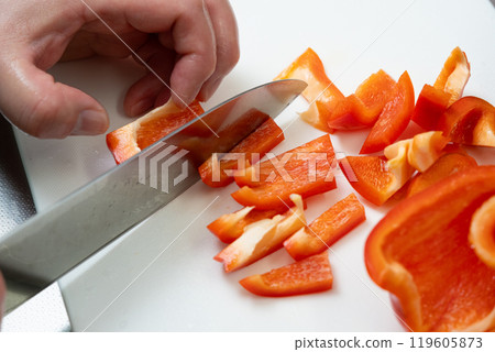Slice the paprika with a knife Slice the paprika with a knife 119605873