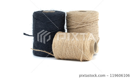 Collection of jute and twine spools on a white background, highlighting natural fiber materials 119606106