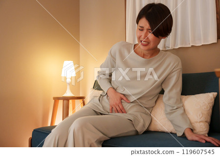 Middle-aged woman with stomach ache at night Middle-aged woman with stomach ache at night 119607545