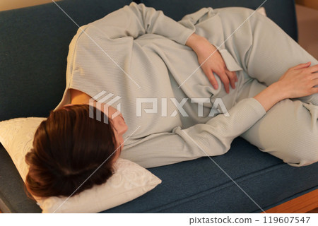 Middle-aged woman with stomach ache at night Middle-aged woman with stomach ache at night 119607547