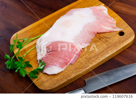 Fresh raw pork secreto fillet (Secreto de cerdo) and condiments prepared for roasting 119607616