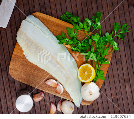 Fresh cod fillet with seasonings ready for cooking Fresh cod fillet with seasonings ready for cooking 119607624