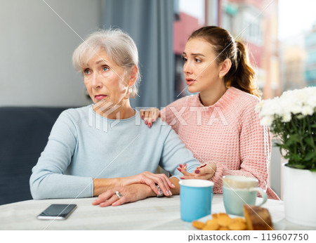 Young woman trying to apologize to offended mother at home 119607750