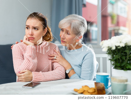 Mother encouraging her depressed adult daughter 119607770