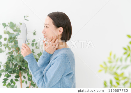 Woman doing skincare with a smile 119607780