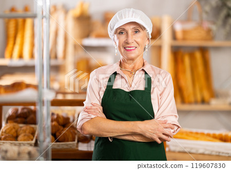Portrait of professional elderly female baker in uniform in bakery 119607830