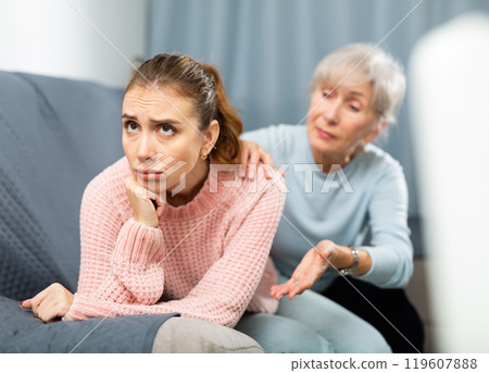 Mother encouraging her depressed adult daughter 119607888
