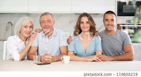 Family of four sitting in kitchen Family of four sitting in kitchen 119608219