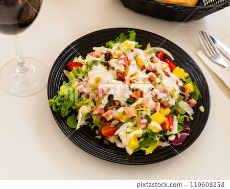 Colorful salad of greens, tomatoes, pineapple, bacon, walnuts 119608258