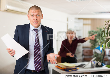 Male office worker confused by his chief shouting 119608263