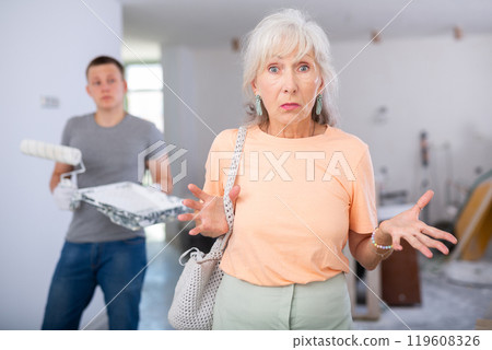 Woman dissatisfied with progress of repair works Woman dissatisfied with progress of repair works 119608326