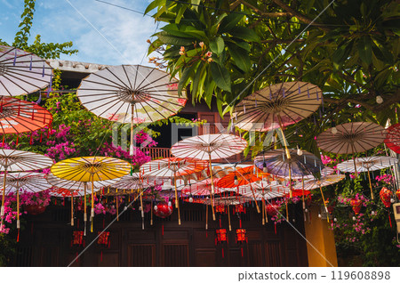 Colorful decorative Asian Japanese umbrellas decorate street in Hoi an in Asia 119608898