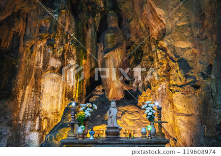 Buddhist temple with statues and a sanctuary inside Tong Chon Cave in the Marble Mountains in Da Nang in Vietnam 119608974
