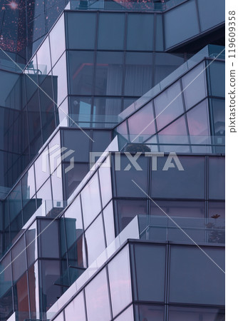 Architecture exterior of Modern building with many glass wall reflecting with the sky background at afternoon. Architecture exterior of Modern building with many glass wall reflecting with the sky background at afternoon. 119609358