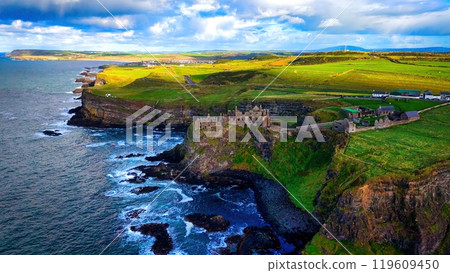 Dunluce Castle in Northern Ireland aerial view - Ancient Ruins Majestically Overlooking the Glorious 119609450