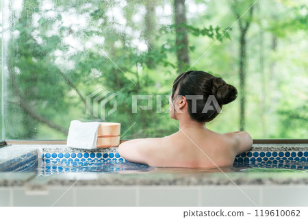 A woman bathing in a hot spring bath at a hot spring inn or private bath A woman bathing in a hot spring bath at a hot spring inn or private bath 119610062