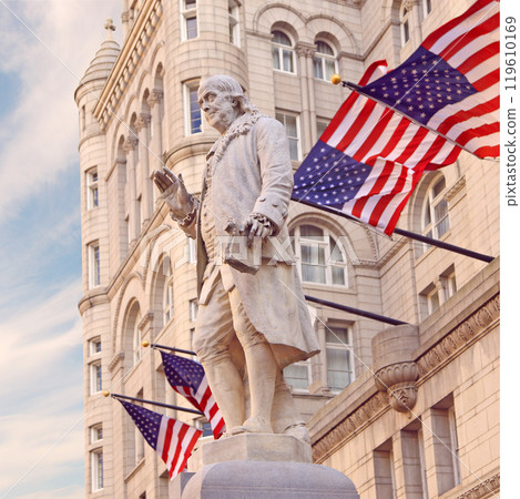 Old Post Office building with Benjamin Franklin Statue and American flags 119610169