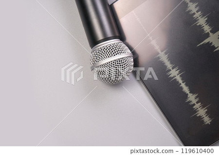 Recording tools: microphone and tablet with sound waves for professional editing 119610400