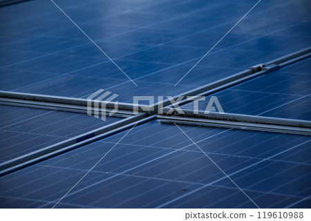 closeup photovoltaic panels which installed on the rooftop of the building, concept for storing and using natural power from the sunlight to care about human environment over the world. closeup photovoltaic panels which installed on the rooftop of the building, concept for storing and using natural power from the sunlight to care about human environment over the world. 119610988