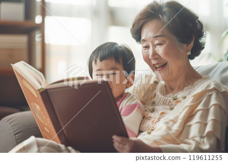 Asian family, happy grandmother reading with grandson on sunny afternoon Asian family, happy grandmother reading with grandson on sunny afternoon 119611255