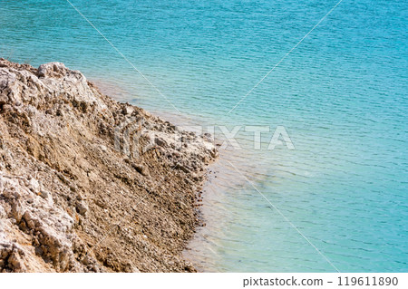 Turquoise water in a flooded clay quarry 119611890
