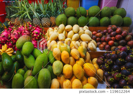 assortment of tropical fruits on market in Asia. Exotic fruits on counter in a street store in Vietnam. Mango, pitahaya, pineapple, mangosteen and passion fruit assortment of tropical fruits on market in Asia. Exotic fruits on counter in a street store in Vietnam. Mango, pitahaya, pineapple, mangosteen and passion fruit 119612264