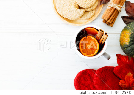 Cup of mulled wine with slices of orange and cinnamon sticks. Cup of mulled wine with slices of orange and cinnamon sticks. 119612578