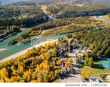 Aerial view of Bow river in autumn. Canmore, Alberta, Canada. Hydroelectric power plants above Town of Canmore in the Canadian Rockies. Aerial view of Bow river in autumn. Canmore, Alberta, Canada. Hydroelectric power plants above Town of Canmore in the Canadian Rockies. 119613282