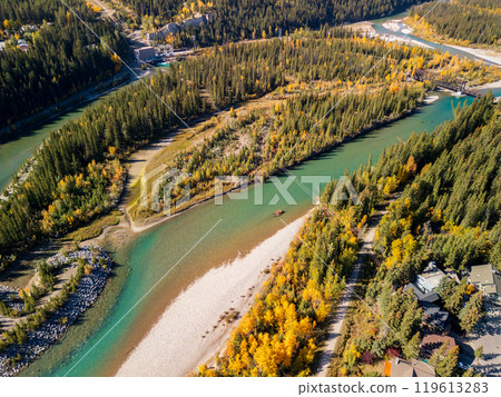 Aerial view of Bow river in autumn. Canmore, Alberta, Canada. Hydroelectric power plants above Town of Canmore in the Canadian Rockies. 119613283