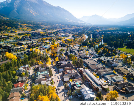 Aerial view of Town of Canmore downtown area in a autumn sunny day. Canadian Rockies mountain range in background. Alberta, Canada. 119613289