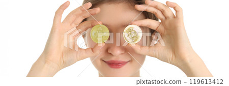Woman holds golden coins with bitcoin symbol against eyes Woman holds golden coins with bitcoin symbol against eyes 119613412