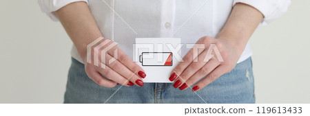 Woman in jeans and shirt shows discharged battery cell image Woman in jeans and shirt shows discharged battery cell image 119613433