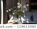 Autumn chrysanthemums in a vase on the living room table 119613980