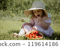 The Joyful Little Girl in a Straw Hat Enjoying 119614186