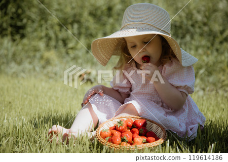 The Joyful Little Girl in a Straw Hat Enjoying The Joyful Little Girl in a Straw Hat Enjoying 119614186