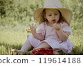 The Joyful Little Girl in a Straw Hat Enjoying 119614188