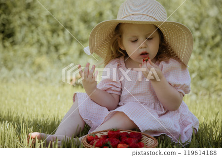 The Joyful Little Girl in a Straw Hat Enjoying The Joyful Little Girl in a Straw Hat Enjoying 119614188