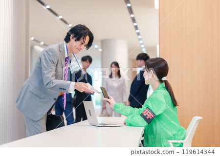 Conference reception staff and participants 119614344