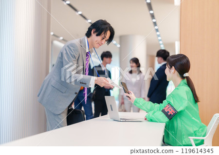 Conference reception staff and participants Conference reception staff and participants 119614345