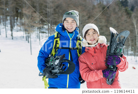 Couple enjoying snowshoes 119614411