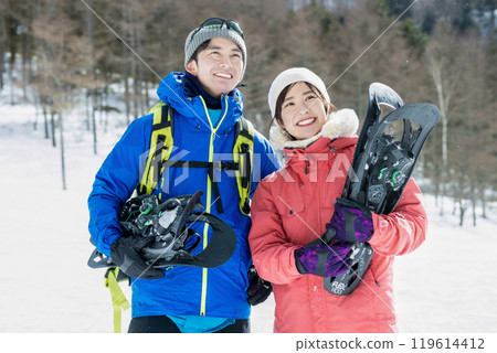 Couple enjoying snowshoes Couple enjoying snowshoes 119614412