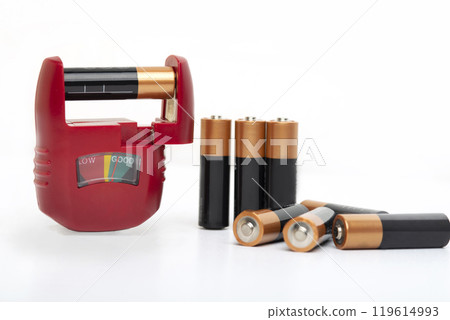Battery tester, battery level indicator with assortment of dry cells for testing on a white background Battery tester, battery level indicator with assortment of dry cells for testing on a white background 119614993