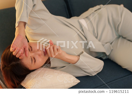 Woman feeling unwell at night 119615211
