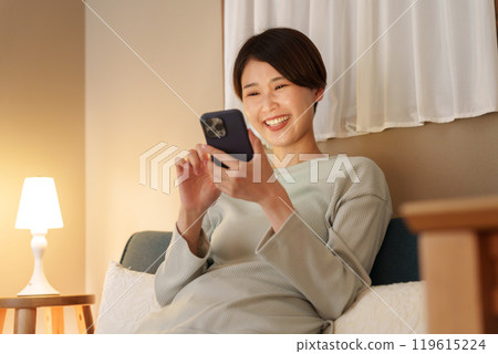 A woman watching a night smartphone A woman watching a night smartphone 119615224