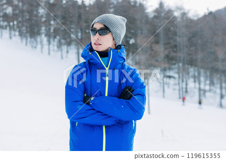 Man looking at snowy mountains Man looking at snowy mountains 119615355