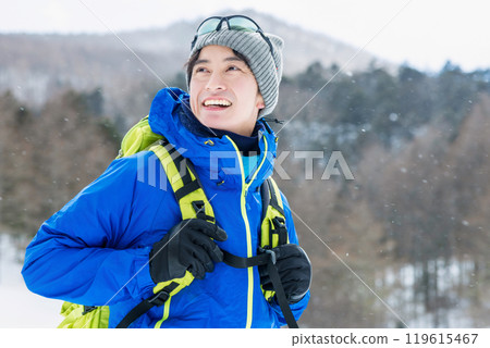 Man looking at snowy mountains Man looking at snowy mountains 119615467